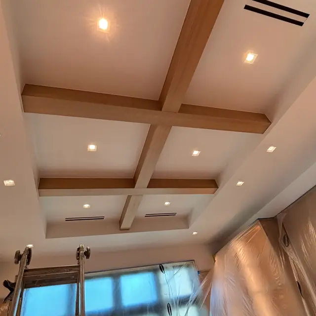 Coffered ceiling with stained wood beams and recessed lighting