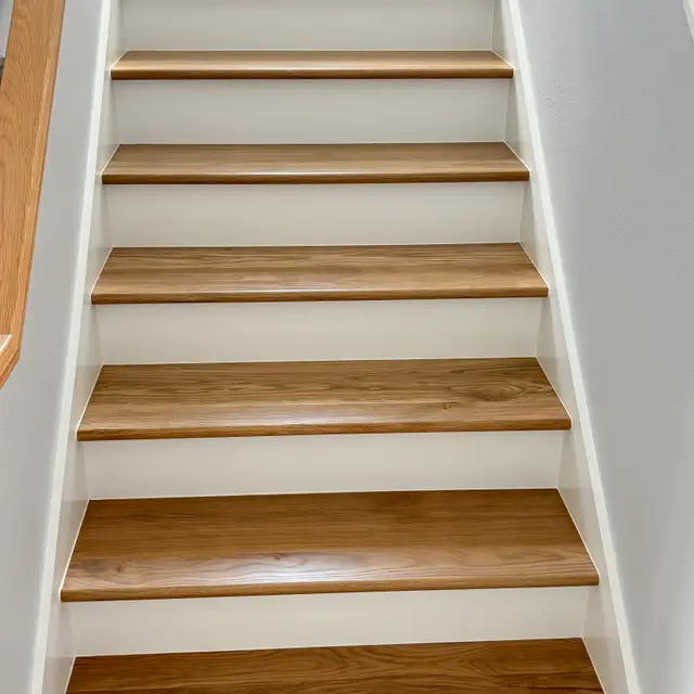 Staircase with stained wood treads and white painted risers