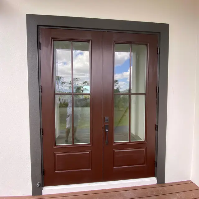 Double glass entry doors stained a rich mahogany